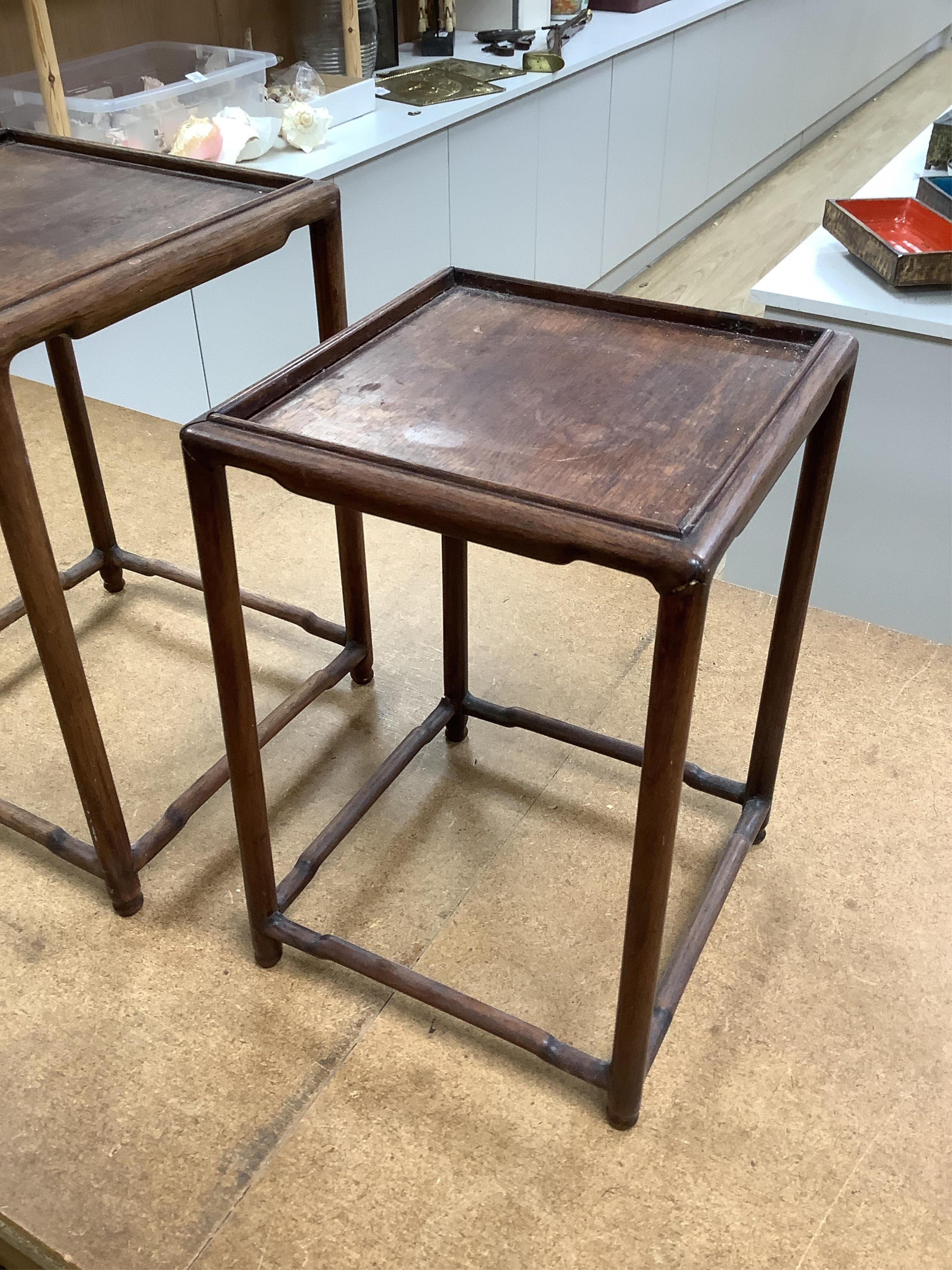 A nest of five Chinese hardwood stands, tallest (largest) 32cm high